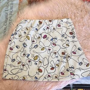 Rainbow White Mini Skirt with Abstract Multi-Face Print